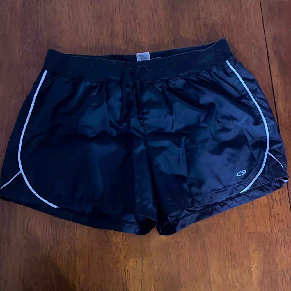 Black athletic shorts with white piping